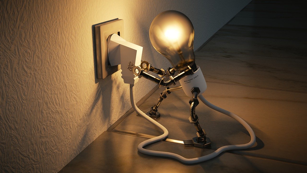 Image of a light bulb plugin itself into the wall